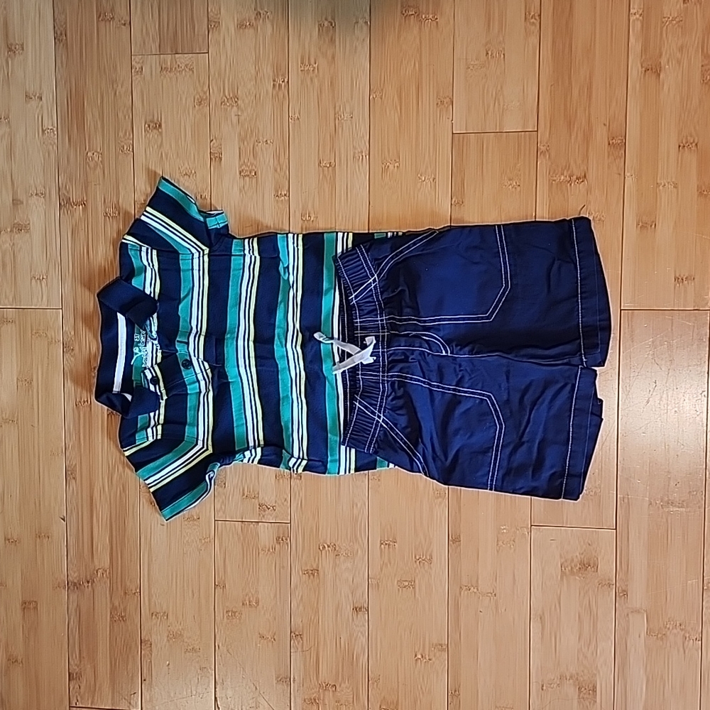 Shirt and shorts set includes green and blue polo shirt with blue shorts.